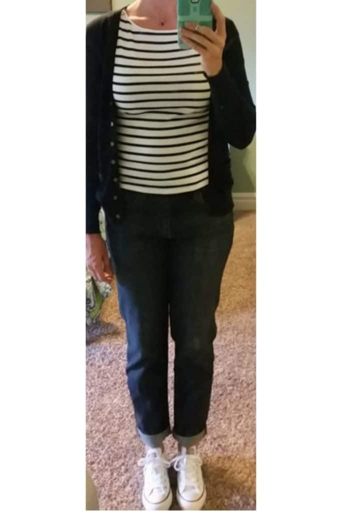 Striped top with black cardigan and jeans.