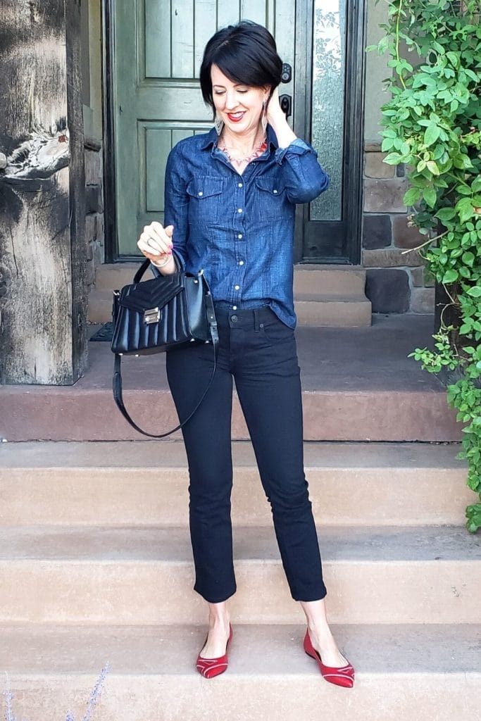 April from Stunning Style wearing a blue denim top and black pants.