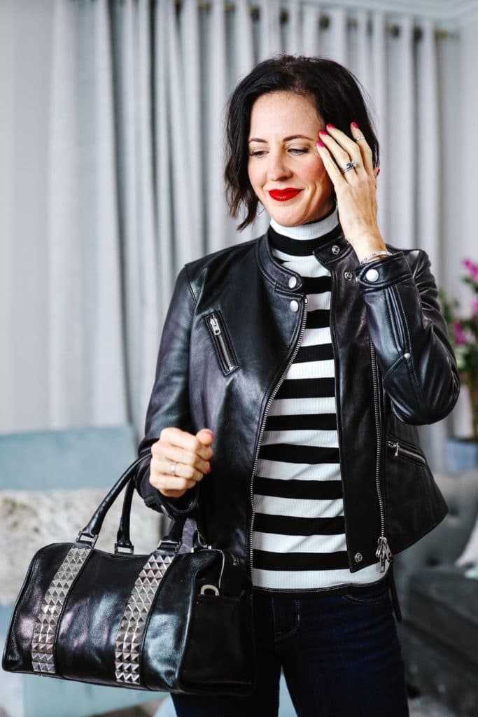 April from Stunning Style showing off her signature edgy classic style by wearing a leather jacket, leather bag and bold stripe pattern top.