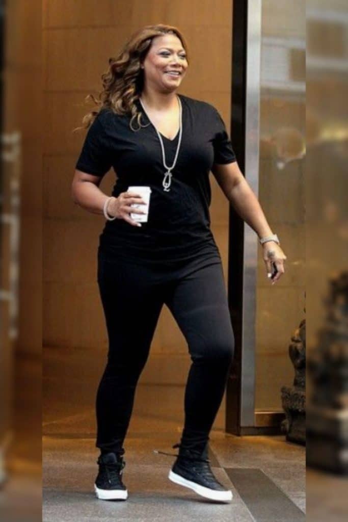 Queen Latifah wearing a black top and black pants.