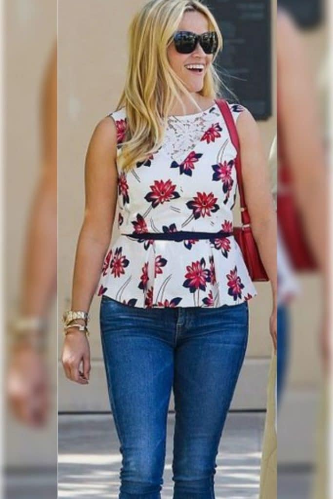 Reese Witherspoon showing off her signature silhouette by wearing a peplum top.