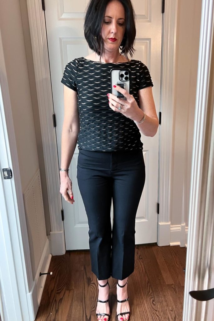 April from Stunning Style wearing a patterned top with black pants.